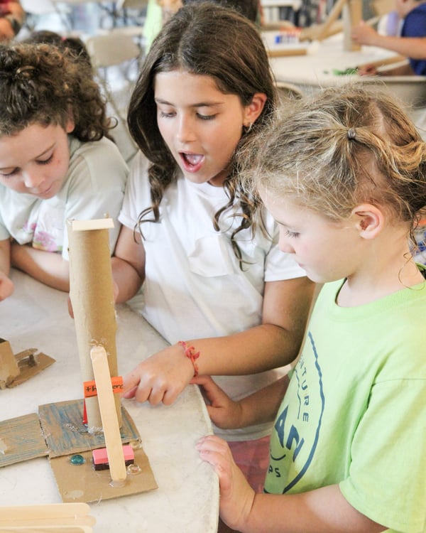 Campers building and testing structures at DEAN Lost Treasure of Coral Island STEAM camp