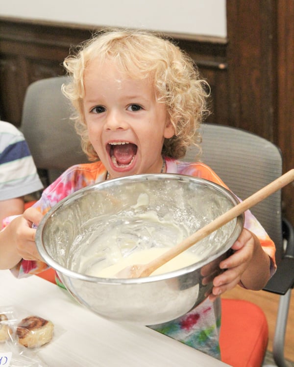 Camper mixing ingredients in a bowl at DEAN Science Sleuths STEAM camp