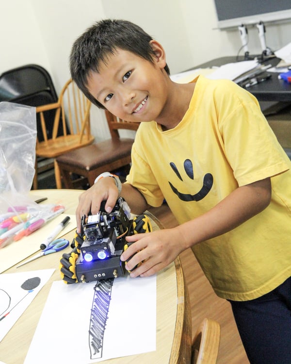 Camper testing a robot rover at DEAN Space Station Rescue STEAM camp
