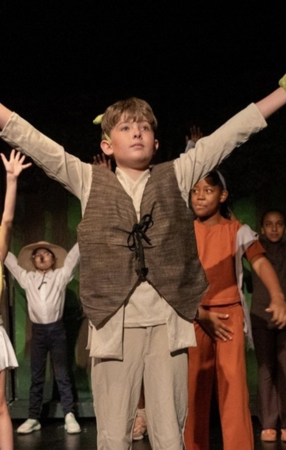 Camper performing on stage in costume in Performing Arts camp